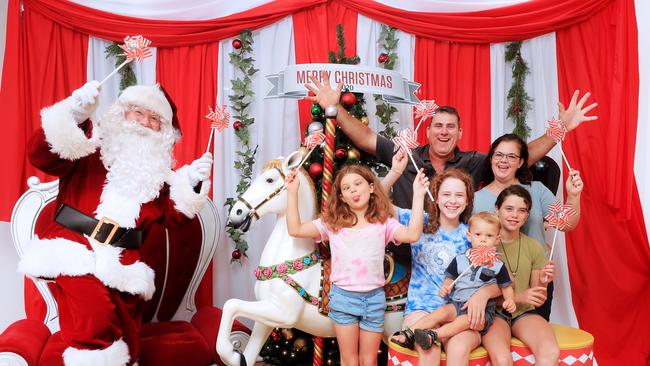 Ben and Wendy Lemmon along with their children, Isabella, 13, Amelia, 11, Charlotte, 8, and Charles, 2, get their COVID Santa photos at The Pines Shopping Centre, Elanora. Photo: Scott Powick