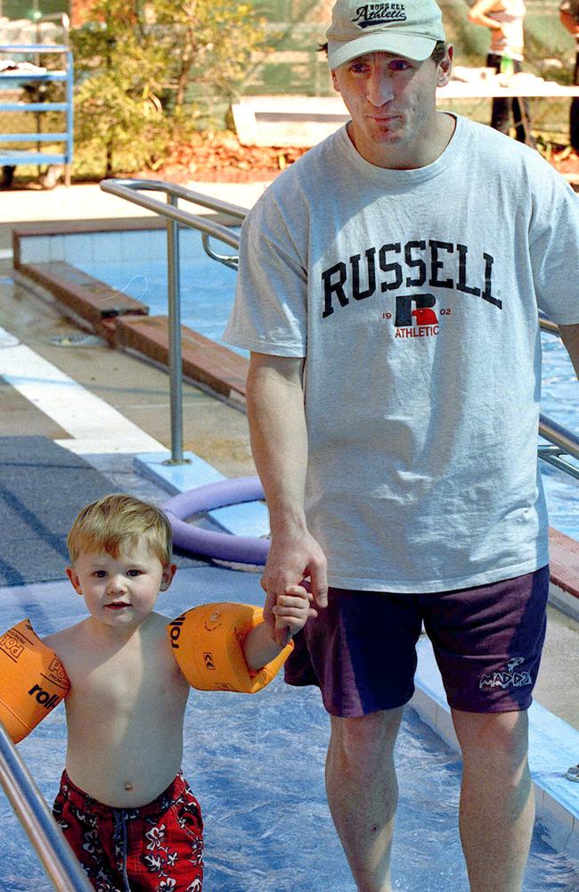 Flashback: Bailey Lambert with his father, Craig, at a Brisbane Lions Father’s Day barbecue in 2001.