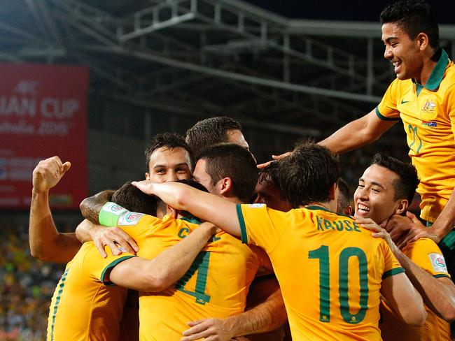 SYDNEY, AUSTRALIA - JANUARY 13: Matt McKay of Australia celebrates with team mates after scoring a goal during the 2015 Asian Cup match between Oman and Australia at ANZ Stadium on January 13, 2015 in Sydney, Australia. (Photo by Brendon Thorne/Getty Images)