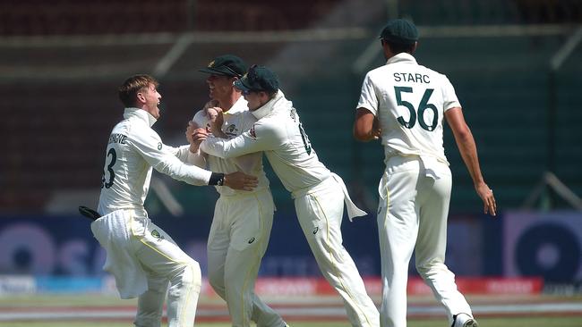 Australia's Mitchell Swepson (2L) was in the thick of it on day three of the second Test, running out Abdullah Shafique. Picture: AFP