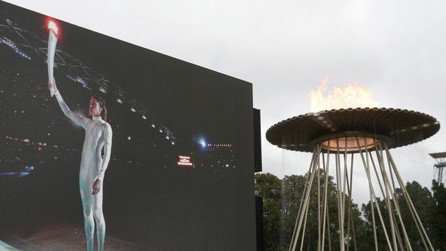 Alight once again … the cauldron at Sydney Olympic Park today with a backdrop of the Cathy Freeman’s moment 20 years ago. Picture: Mark Kolbe