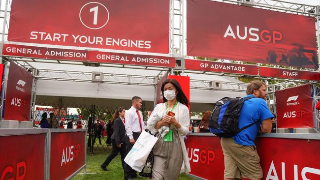 Spectators leave Albert Park after the Grand Prix was cancelled. Picture: AAP Image/Scott Barbour