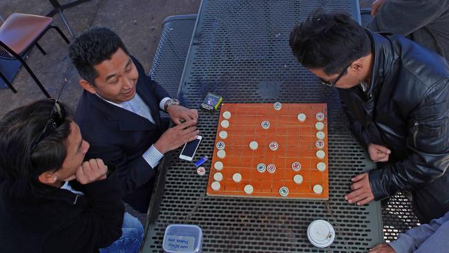 A game of Vietnamese Chess is played the middle of the Inala Square.  