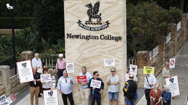 Parents protesting Newington’s coeducation move outside the Stanmore school as boys arrive for their first day of the new school year. Picture: Richard Dobson