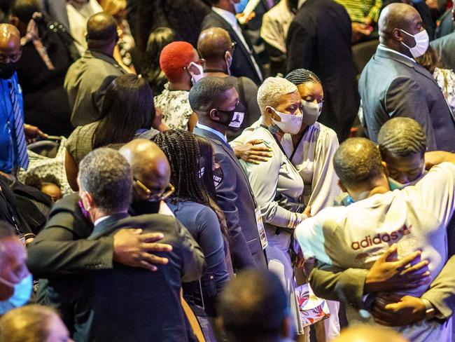 Attendees, including members of George Floyd's family, hug each other during a memorial service in his honour in Minneapolis, Minnesota. Picture: AFP