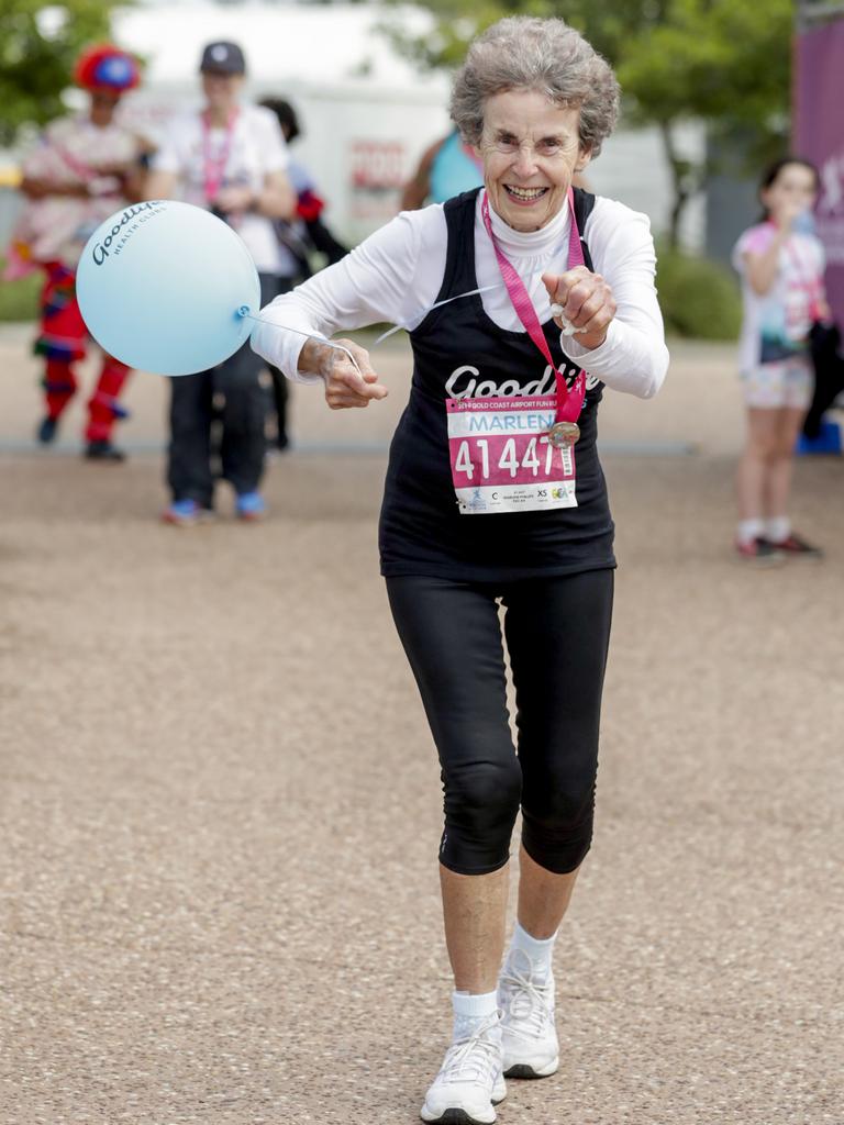 Marlene Phillips, from Ashmore who is turning 80 tomorrow celebrates at the finish the Gold Coast Airport Fun Run. Pics Picture: Tim Marsden.