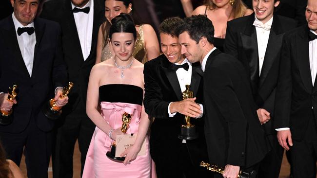 US producer Alex Coco, US filmmaker Sean Baker and US actress Mikey Madison accept the award for Best Picture for "Anora" onstage during the 97th Annual Academy Awards at the Dolby Theatre in Hollywood, California on March 2, 2025. (Photo by Patrick T. Fallon / AFP)