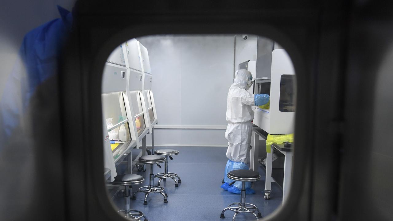 This photo taken on February 6, 2020 shows a laboratory technician working on samples from people to be tested for the new coronavirus at "Fire Eye" laboratory in Wuhan in China's central Hubei province. Picture: STR / AFP