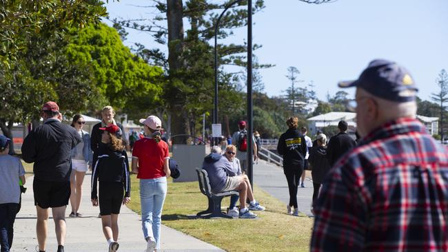 Walkers at the Wynnum foreshore this morning. Picture: Renae Droop