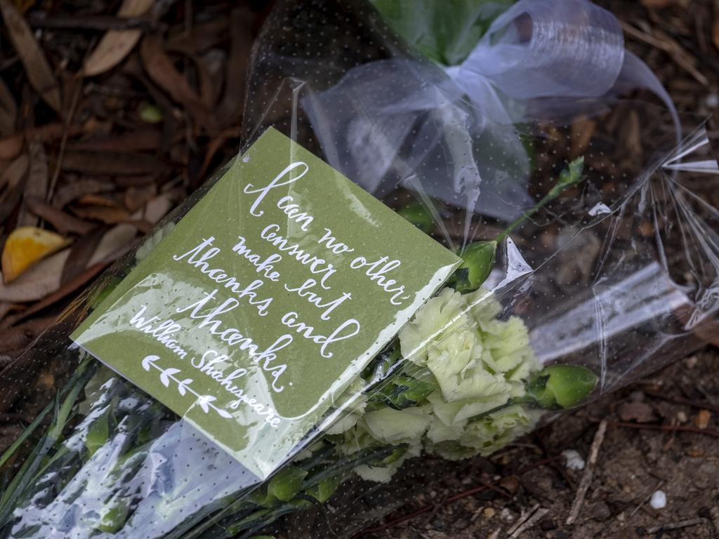 Floral tributes are beginning to pile up outside Boroondara Police station. Picture: Luis Ascui/Getty Images