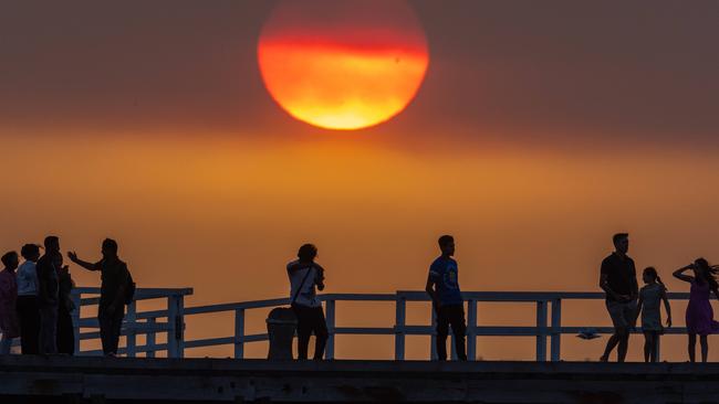 Sunset over Port Melbourne through bushfire smoke haze. The sun glowed red after the cool change swept through. Picture: Jason Edwards