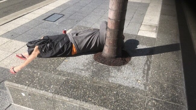 A person lying on Scarborough Street in Southport. Picture: Dale Anderson.