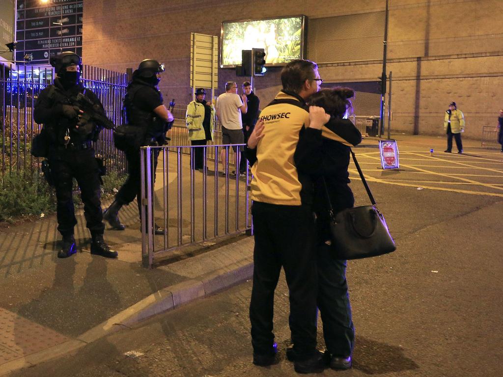 Armed police stand guard at Manchester Arena after reports of an explosion at the venue during an Ariana Grande concert in Manchester, England. Picture: AP