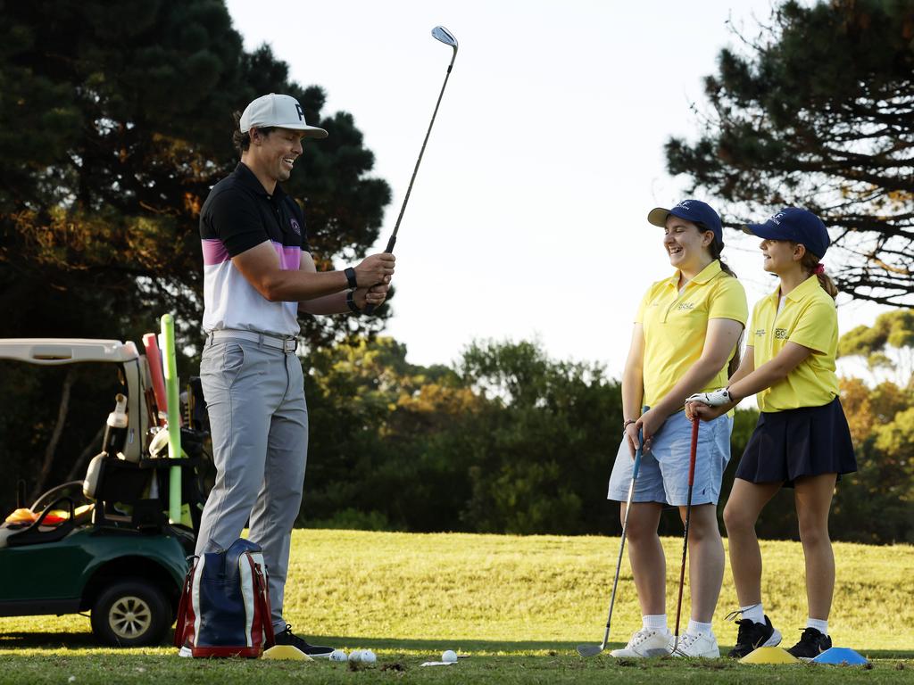James Edge PGA professional teaching Elizabeth Savell, 14, and Eliza Rolfe, 9, at East Lakes Golf Club in Pagewood. Picture: Jonathan Ng