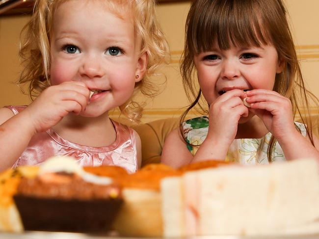 Three 3yo children enjoying a special children's afternoon tea at the Windsor Hotel. It is being created especially for the school holidays. Xander, 2, Isabella, 3 (pink dress blonde hair) and Alyssa, 2 (brown hair). Picture: Tim Carrafa