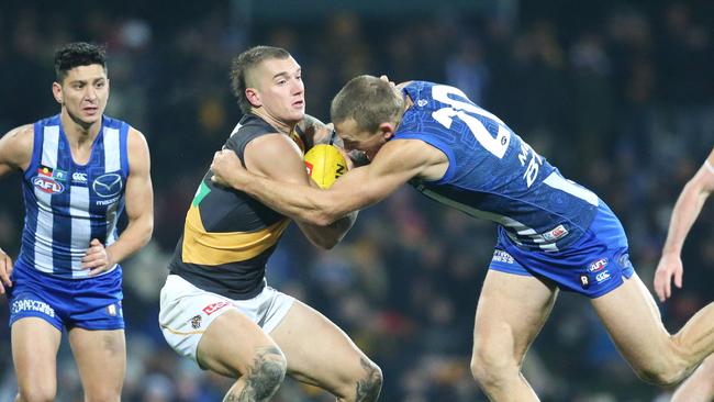 Dustin Martin is tackled by Drew Petrie. Picture: Nikki Davis-Jones