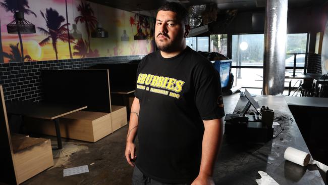 Owner of Grubbies Ben Niumata in his burnt and damaged Strathpine store. Picture: Liam Kidston