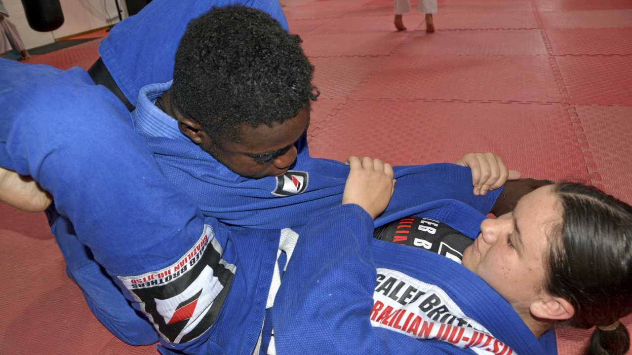 MAT WORK: Keely Geiger works on a triangle choke with Emmanuel Fallah. Geiger will compete at the Australian Brazilian Jiu Jitsu Federation championships in Melbourne on August 11. The Galeb Brothers BJJ athlete earned her spot at the championships after winning gold in the U15 Open Girls Gi division at the Queensland championships. Picture: Jason Gibbs