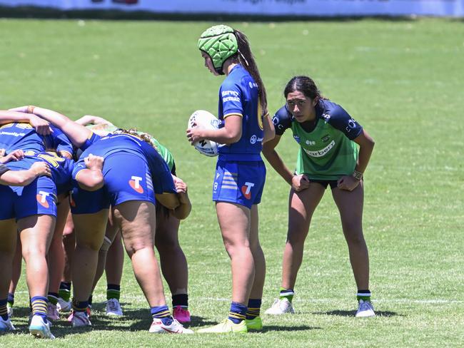 Sammy-Lee Gunn-Tauai feeds the scrum as Sabrina Marela watches on. Picture: Martin Ollman