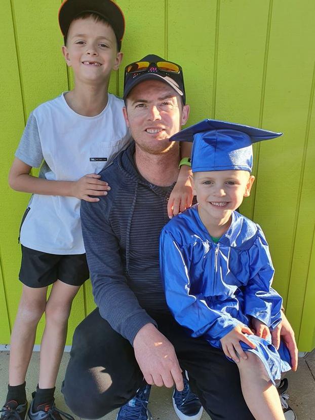 Anthony West with his boys Oakley, 9, and Deighton, 5, at Deighton’s kinder graduation ceremony in December.