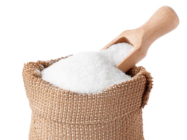 sugar with scoop in burlap sack isolated on white background. Full bag of sugar crystals closeup