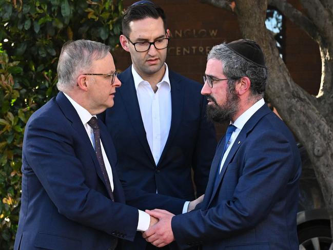 Australian Prime Minister Anthony Albanese (left) and Labor member for MacNamara Josh Burns are greeted by Rabbi Yaakov Glasman (right) during a visit to the St Kilda Shule in Melbourne, Wednesday, October 11, 2023. (AAP Image/James Ross) NO ARCHIVING