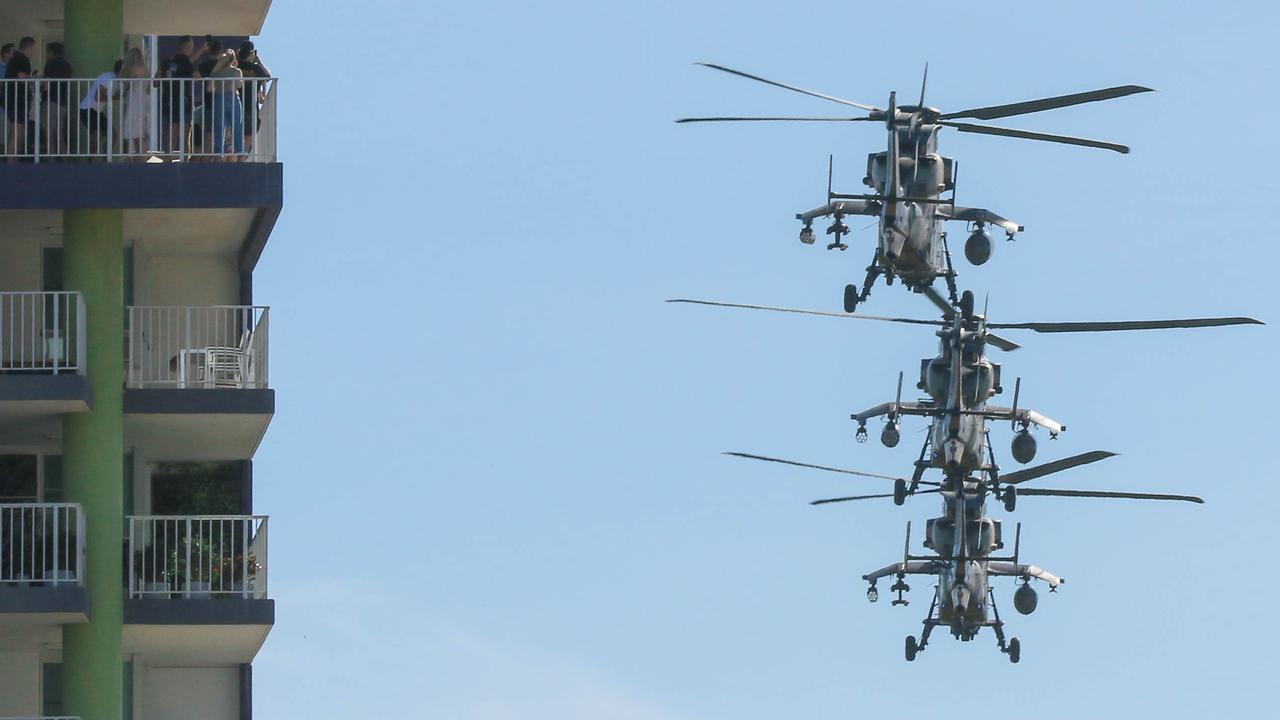 Attack Helicopters conduct a flypast during the march on Darwin's Knuckey St commemorating ANZAC Day 2021. Picture Glenn Campbell