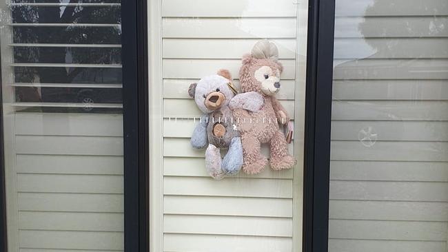 A teddy duo grace a Pakenham window.