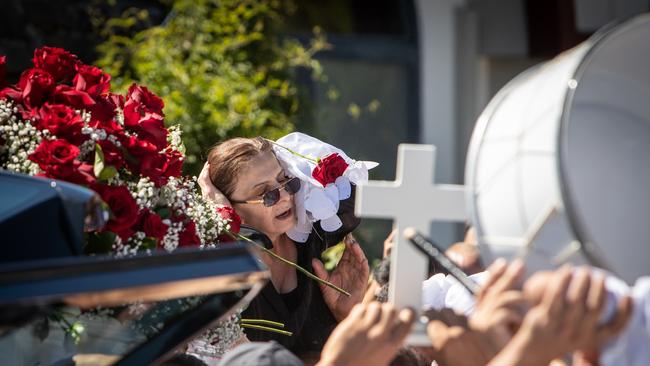 Crying family members walked slowly behind the hearse.