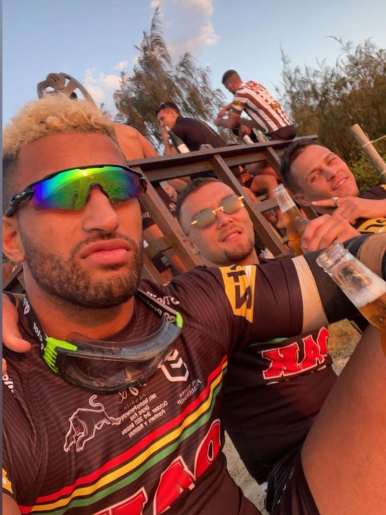 Viliame Kikau and James Fisher-Harris hit the beach with their teammates on the morning after their grand final win.