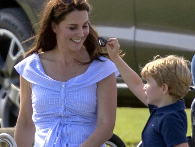 The Duchess of Cambridge smiles at Prince George as they watch Prince William take part in the Maserati Royal Charity Polo Trophy. Picture: Steve Parsons/PA