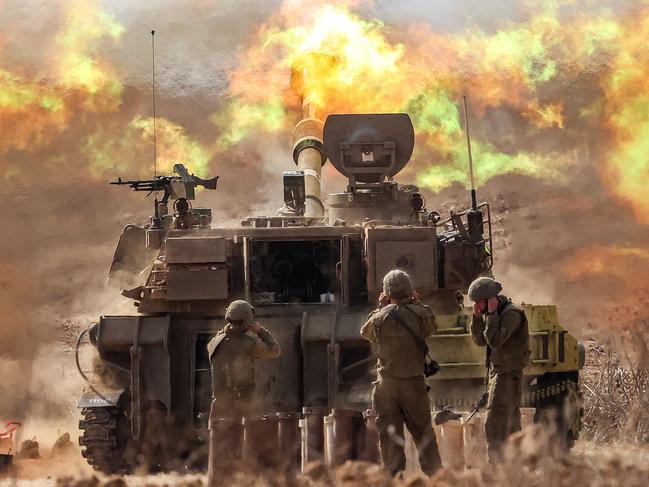 An Israeli army self-propelled howitzer fires rounds near the border with Gaza.