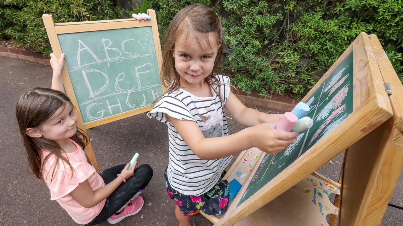 Coco, 6 and Yumi, 4, write with chalk. Picture: Tim Carrafa