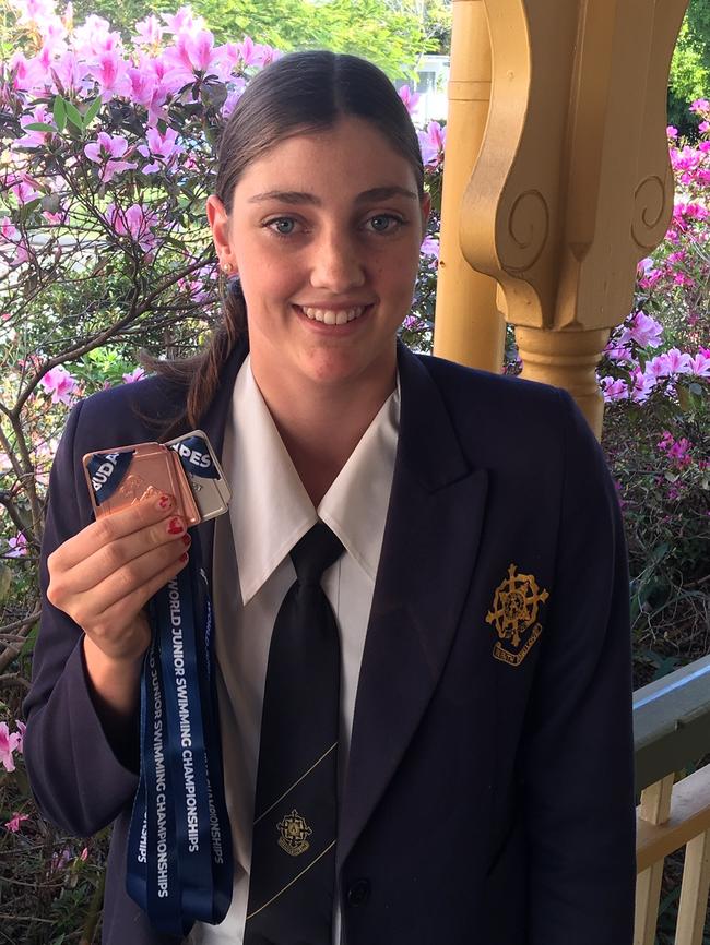 Meg Harris at Mt St Michael’s with her swim world junior medals