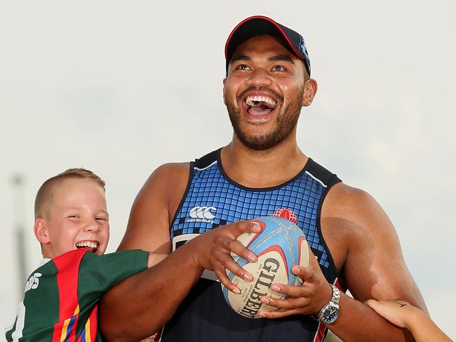 Bidwill product Senio Toleafoa of the Waratahs is tackled by Western Raptors Junior Rugby Union club players Faith Manu 10, Jai Parkes 10, Brayden Parkes 10 and Ezekiel Oto 11 at a Rugby clinic held by the Waratahs at Mittigar reserve in Hassall Grove.