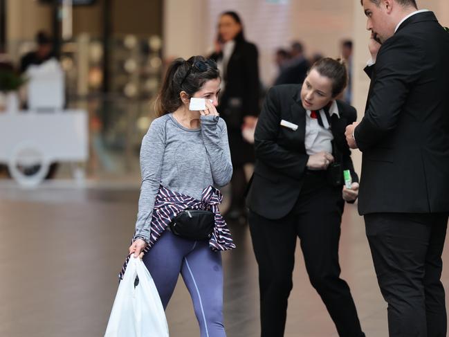 A woman seen wiping away tears as she leaves the centre. Picture: Rohan Kelly