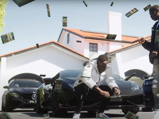 BBG Smokey surrounded by luxury cars in the music video. Picture: Screenshot/YouTube