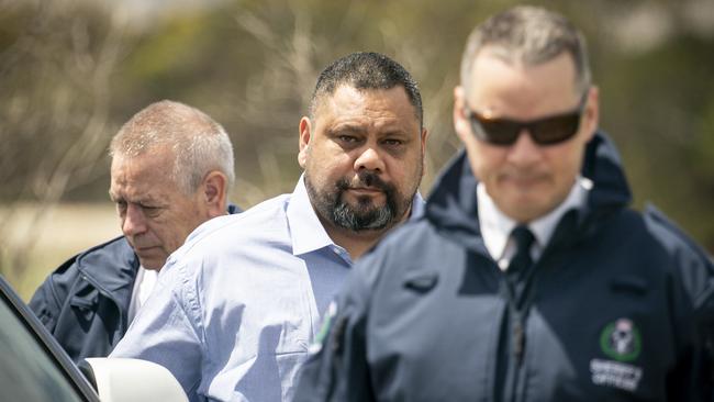 Paul Beveridge Maroroa, centre, with security and legal representatives during a visit to the Maslin Beach carpark where he shot Robert Sabeckis. Picture: AAP / Mike Burton