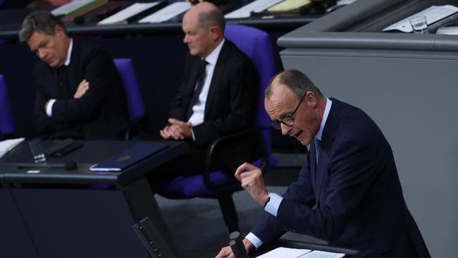 Friedrich Merz, leader of the Christian Democrats, speaks as Chancellor Olaf Scholz looks on during the debate in the Bundestag. Picture: Getty Images.
