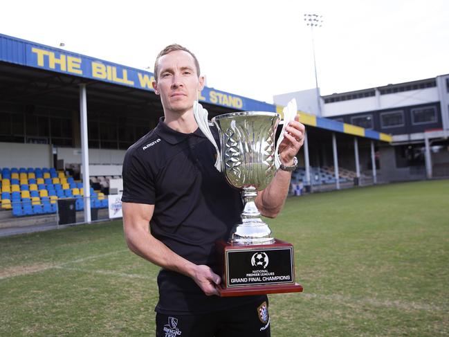 Defender Matt Smith with the NPL Queensland trophy the Gold Coast Knights won last season. Picture: AAP Image/Attila Csaszar