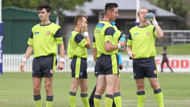 IT’S OFFICIAL: The umpires take a breather at Woodville Oval. Picture: Dean Martin/AAP