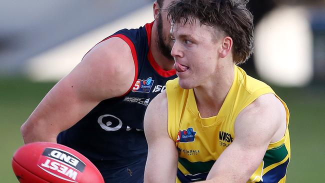 Eagles’ James Rowe gets his handball away against Norwood. Picture: Sarah Reed