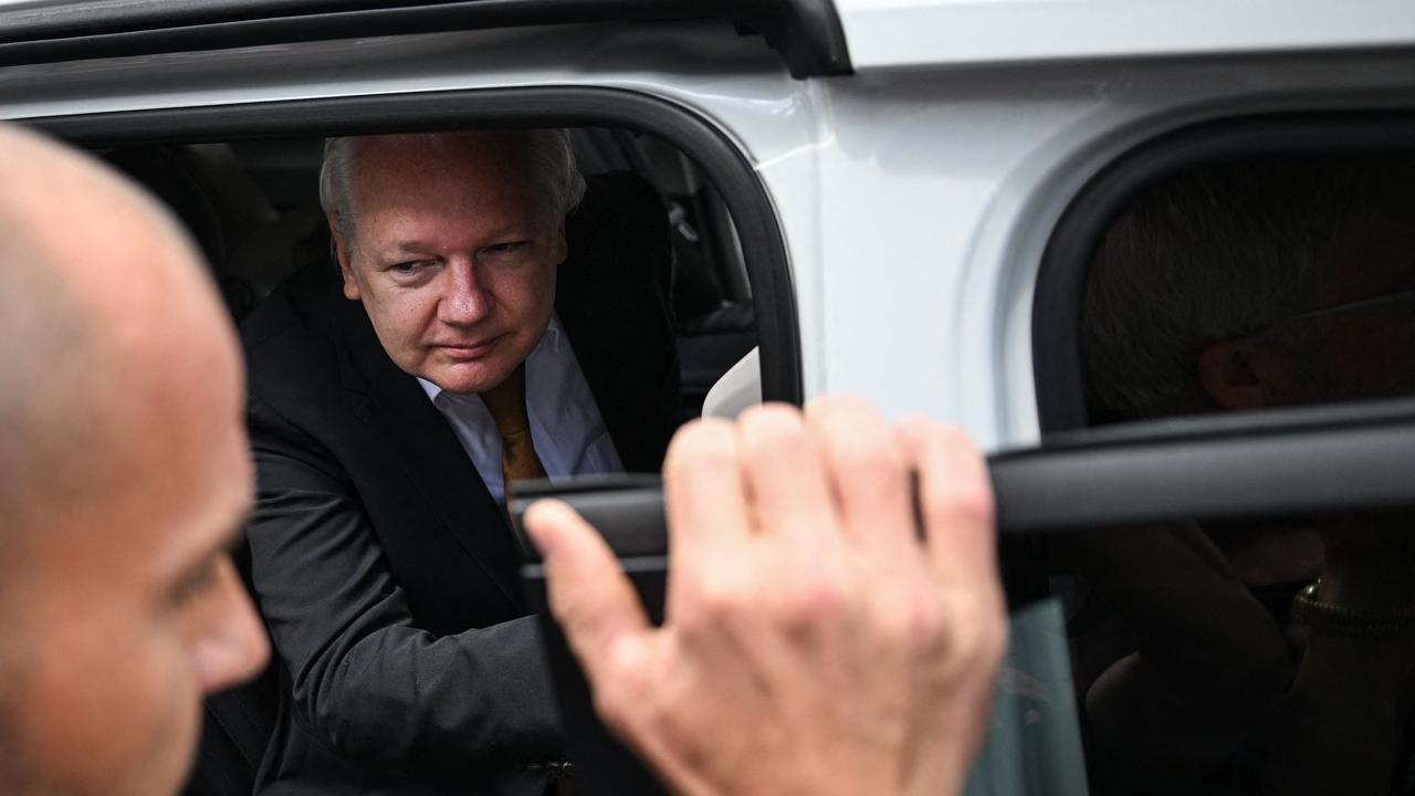 Mr Assange smiled at reporters but didn’t answer questions as he walked to his car after leaving court. Picture: Yuichi Yamazaki / AFP