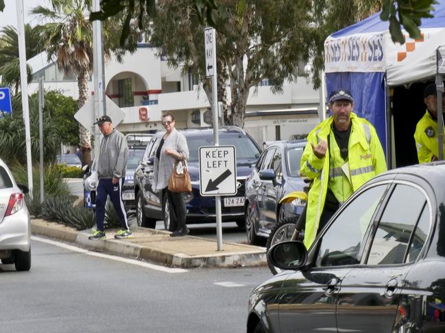 Queensland Police waving through a line of traffic at the Griffith St border check point in Coolangatta on July 9. Photo: Jessica Lamb