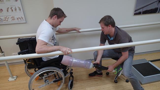 Curtis is fitted with his prosthetic legs.