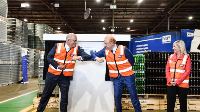 Prime Minister Scott Morrison and Visy Executive Chairman Anthony Pratt elbow bump during a visit to Visy Manufacturing in Penrith. Picture: NCA NewsWire/Flavio Brancaleone