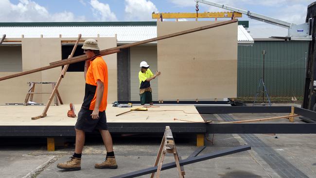 Workers construct prefabricated sustainable homes at Gateway Constructions in Cairns.