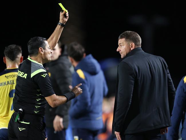 Referee Alireza Faghani, pictured showing Mariners coach Mark Jackson a yellow card during the semi final last week, will not officiate the decider. Picture: Getty Images