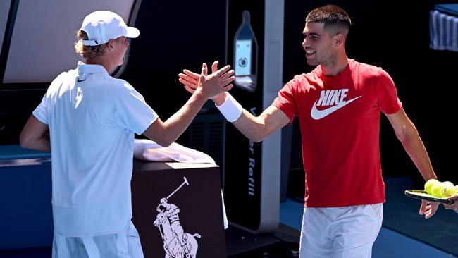 Carlos Alcaraz of shakes hands with hitting partner Cruz Hewitt before a training session ahead of the Australian Open. (Photo by William WEST / AFP)