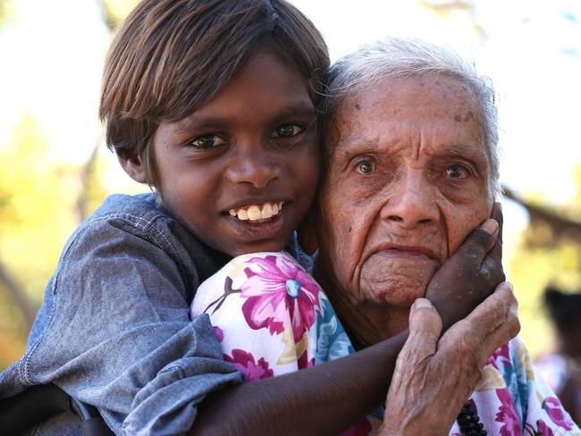 100 yr old Aboriginal woman May Smiler , born in 1914 , one of the very few documented , gets a cuddle from great great grandchild Anzac Paul 9 , during a community celebration for her in Kowanyama , Cape York.